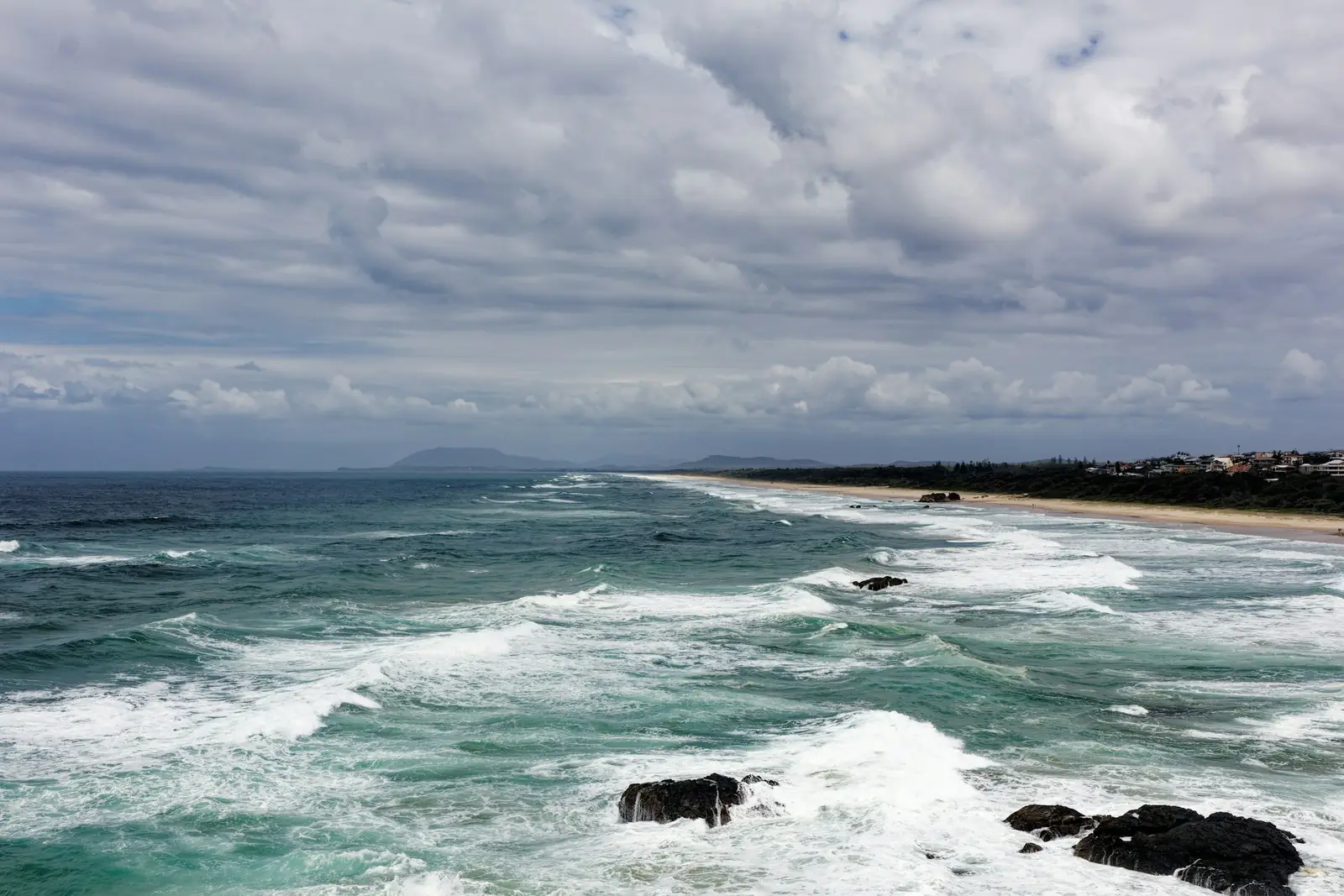 Surf rolling onto a long beach on the Mid North Coast
