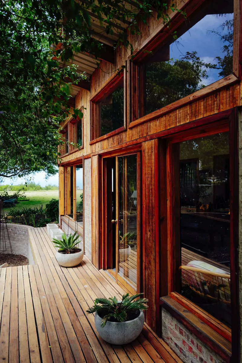 Timber-framed extension opening onto a hardwood deck