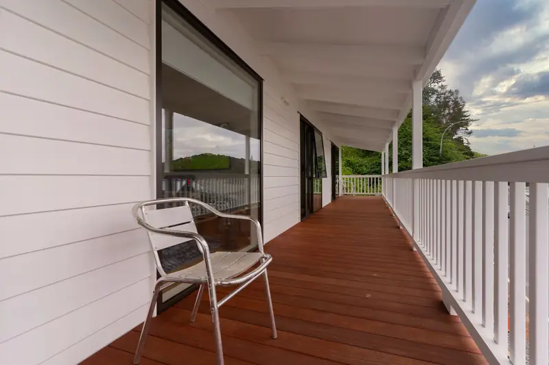 Weatherboard verandah with a new hardwood floor and white balustrade